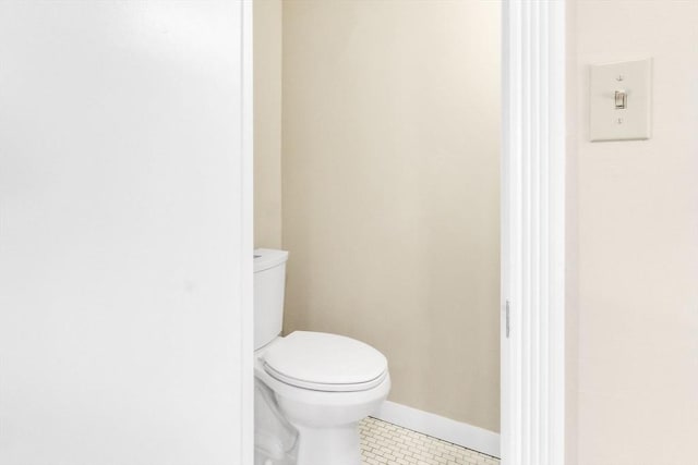 bathroom with tile patterned flooring and toilet