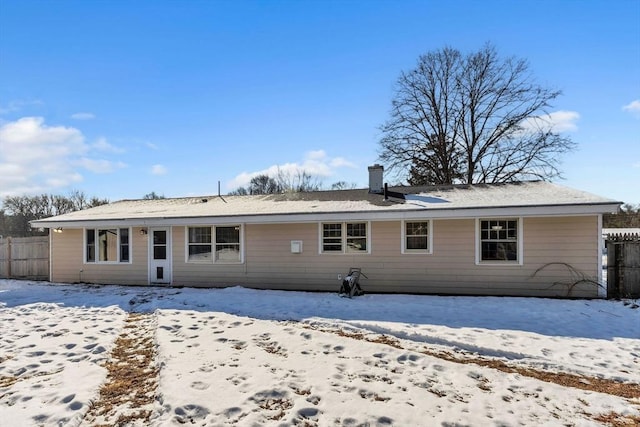 view of snow covered rear of property