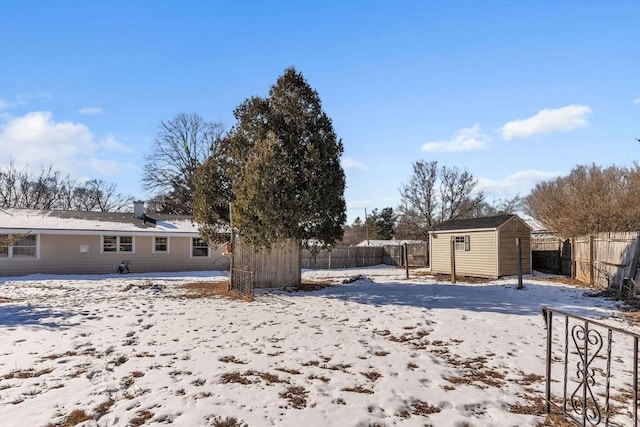 yard covered in snow with a shed