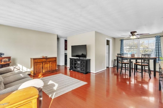 living room with ceiling fan, hardwood / wood-style floors, and baseboard heating