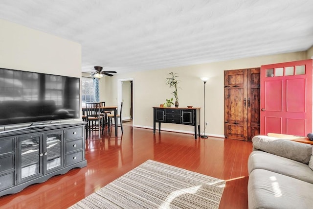 living room with hardwood / wood-style flooring and ceiling fan