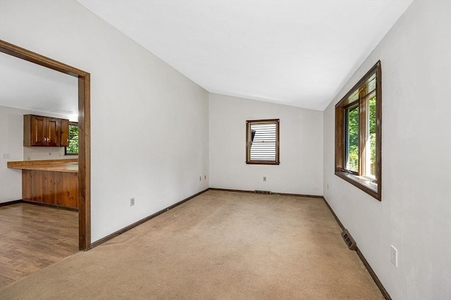 10 Corcoran Dr, Tyngsborough, MA 01879 - spare room with light colored carpet, lofted ceiling, and baseboards