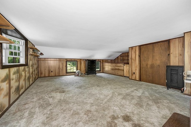 10 Corcoran Dr, Tyngsborough, MA 01879 - unfurnished living room with lofted ceiling, wooden walls, and carpet flooring