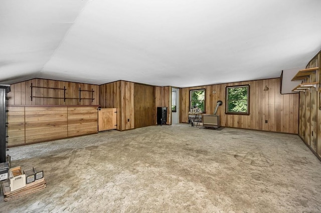 10 Corcoran Dr, Tyngsborough, MA 01879 - additional living space with wooden walls, vaulted ceiling, a wood stove, and carpet flooring