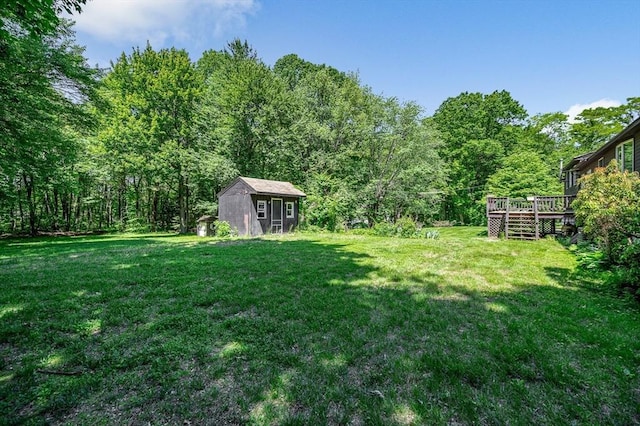 10 Corcoran Dr, Tyngsborough, MA 01879 - view of grassy yard featuring a deck and a forest view
