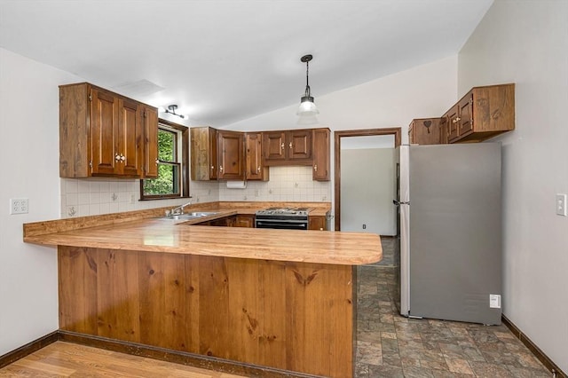 10 Corcoran Dr, Tyngsborough, MA 01879 - kitchen featuring appliances with stainless steel finishes, a peninsula, tasteful backsplash, light countertops, and vaulted ceiling