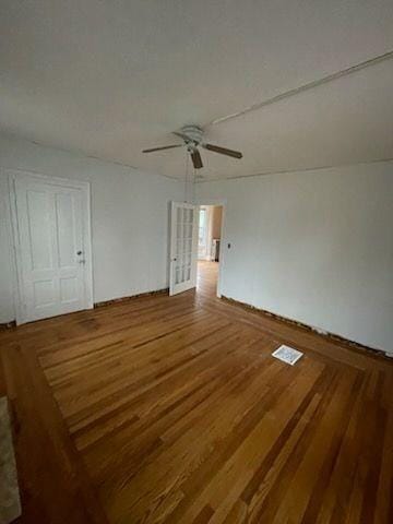 empty room with ceiling fan and wood-type flooring