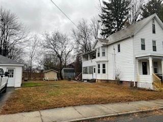 view of side of home featuring covered porch