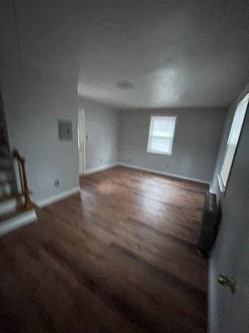 unfurnished living room featuring dark hardwood / wood-style floors