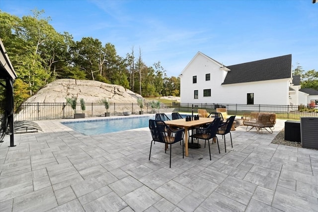 view of pool with a patio area and an outdoor fire pit