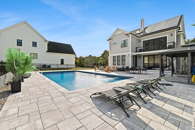 view of pool with pool water feature and a patio