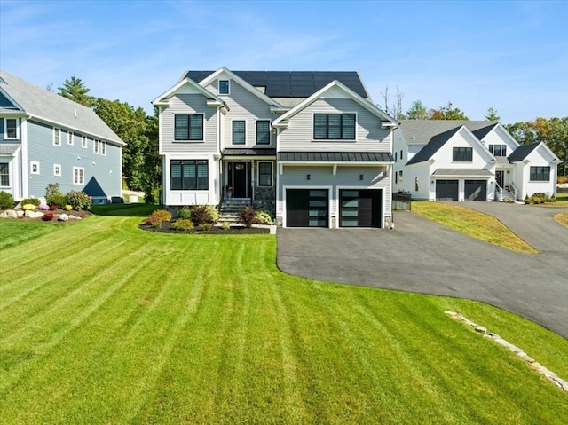 craftsman house featuring a front lawn and a garage