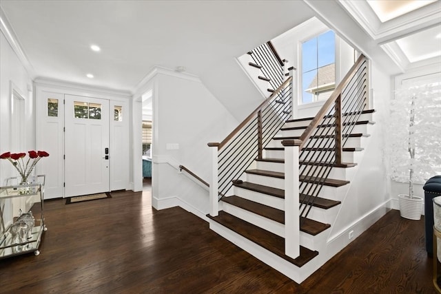 entrance foyer featuring ornamental molding and dark hardwood / wood-style flooring