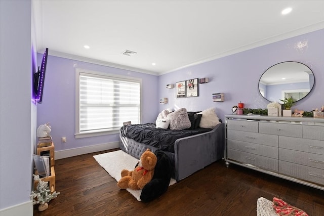 bedroom with crown molding and dark hardwood / wood-style floors