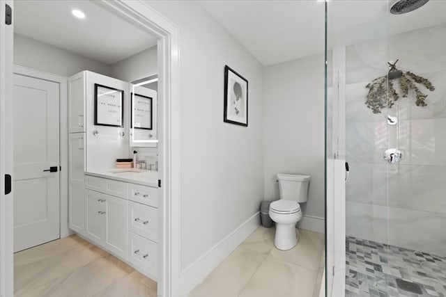 bathroom with toilet, walk in shower, and vanity