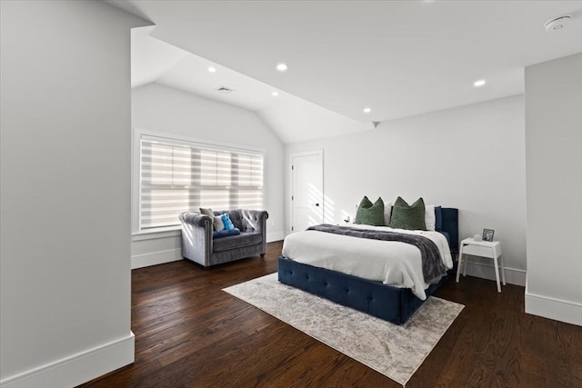 bedroom with lofted ceiling and dark hardwood / wood-style floors