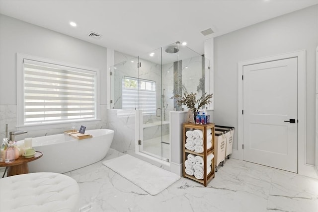 bathroom featuring independent shower and bath