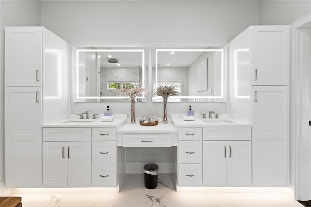 bathroom featuring a shower with door and vanity