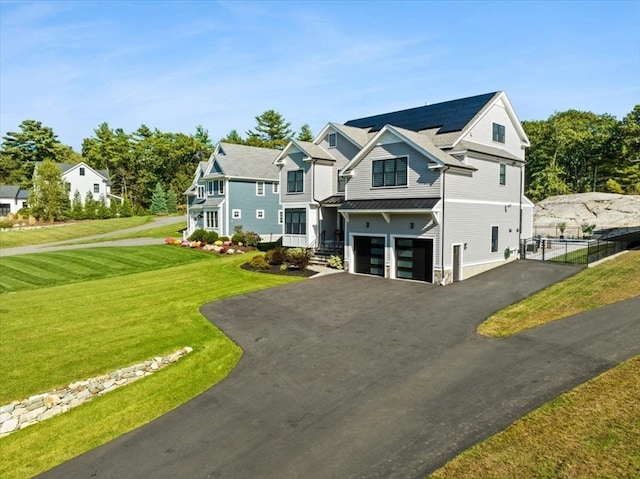 view of front of property featuring a garage and a front lawn