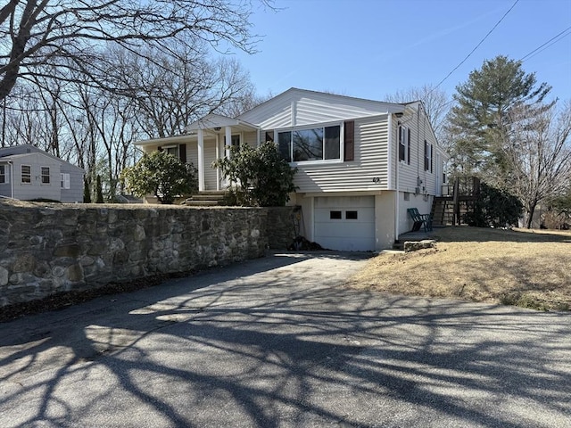 view of property exterior with driveway and an attached garage