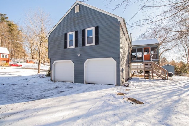 view of snow covered exterior featuring a garage