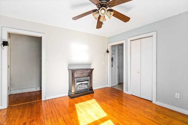 unfurnished living room with hardwood / wood-style flooring and ceiling fan