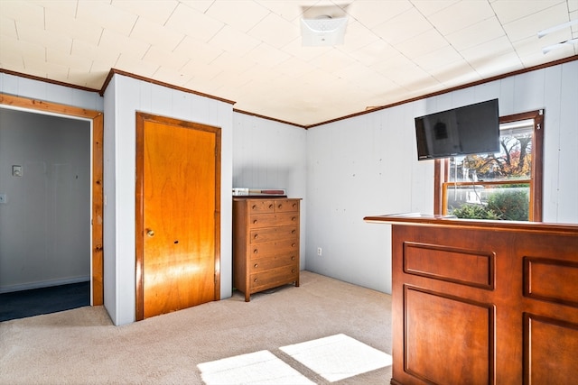 unfurnished bedroom with light colored carpet and crown molding