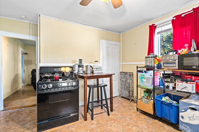 kitchen with ceiling fan, ornamental molding, and black range with gas cooktop