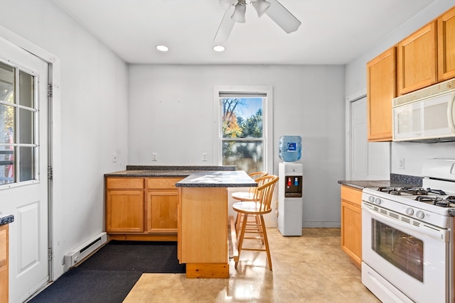 kitchen with white appliances, baseboard heating, ceiling fan, a center island, and a breakfast bar area