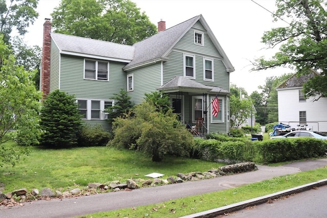 3 Moraine St, Andover, MA 01810 - view of front facade featuring a chimney, a front yard, and a shingled roof