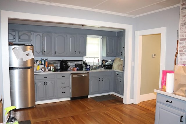 3 Moraine St, Andover, MA 01810 - kitchen featuring stainless steel appliances, ornamental molding, gray cabinetry, dark wood-style flooring, and light countertops