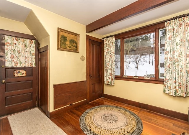 entrance foyer with baseboards, beam ceiling, and dark wood-style flooring