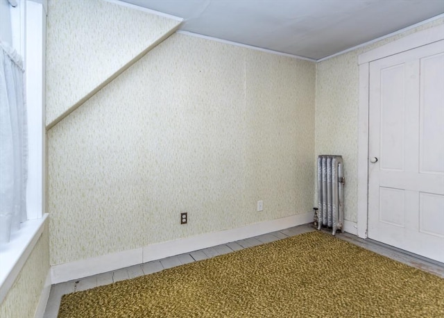 spare room featuring wallpapered walls and ornamental molding