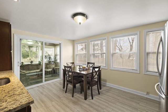 dining space with light hardwood / wood-style floors