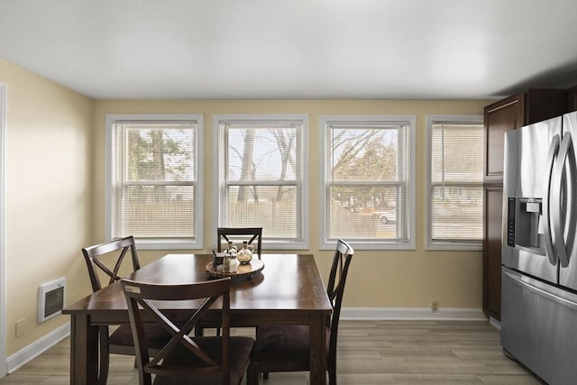 dining room featuring light wood-type flooring and heating unit