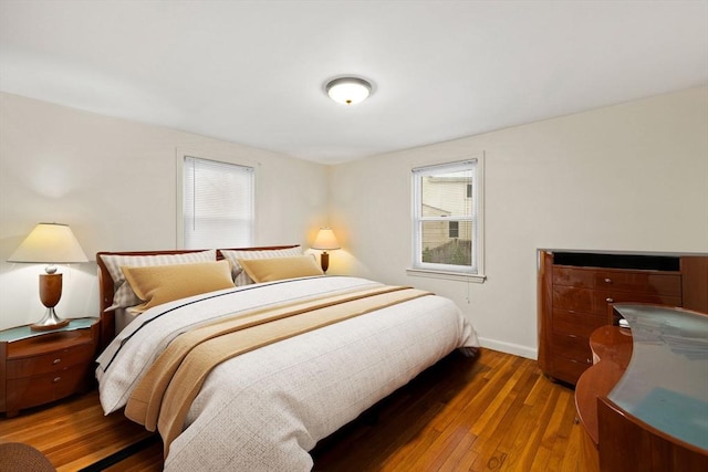 bedroom featuring dark wood-type flooring and multiple windows