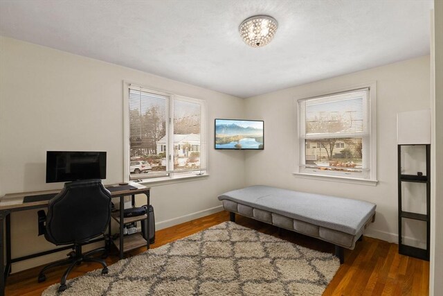 home office with dark hardwood / wood-style floors