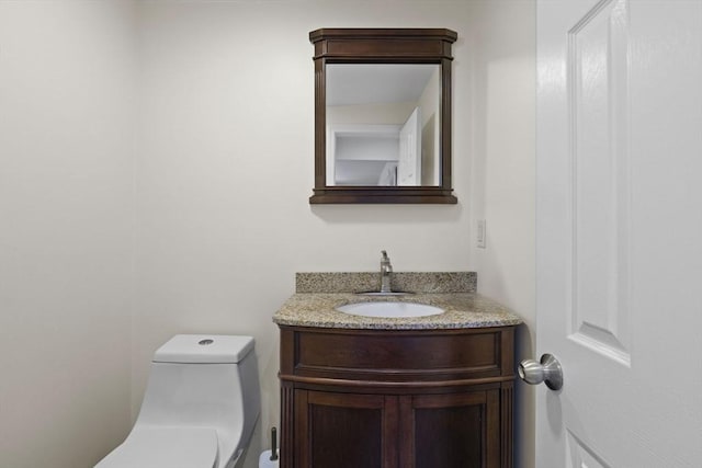 bathroom featuring vanity and toilet