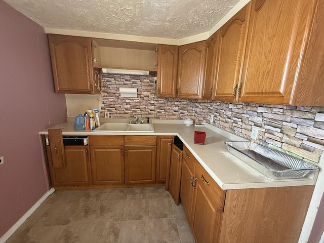 64 Suffolk St, Worcester, MA 01604 - kitchen with brown cabinets, a textured ceiling, tasteful backsplash, and light countertops