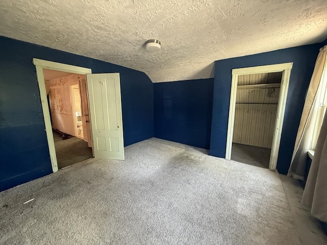 64 Suffolk St, Worcester, MA 01604 - unfurnished bedroom featuring a textured ceiling, a closet, carpet flooring, and vaulted ceiling