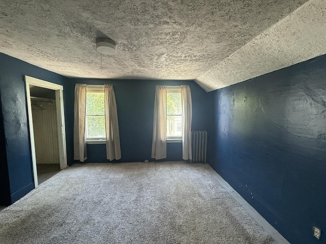64 Suffolk St, Worcester, MA 01604 - unfurnished bedroom featuring carpet, radiator, a textured ceiling, a closet, and vaulted ceiling