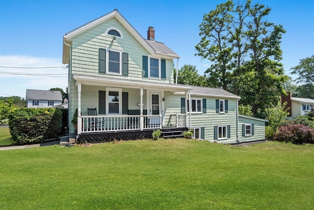 view of front of house with a front yard and a porch