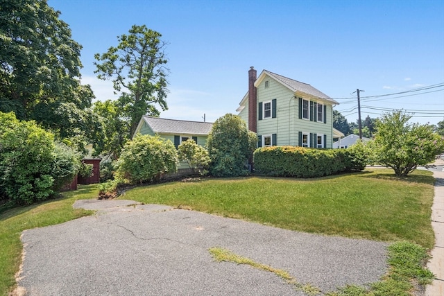 view of side of home featuring a lawn