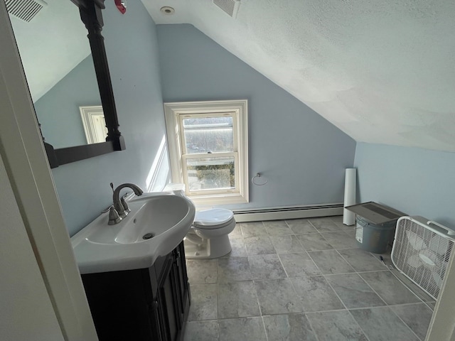 bathroom with a baseboard heating unit, vanity, tile patterned flooring, lofted ceiling, and toilet