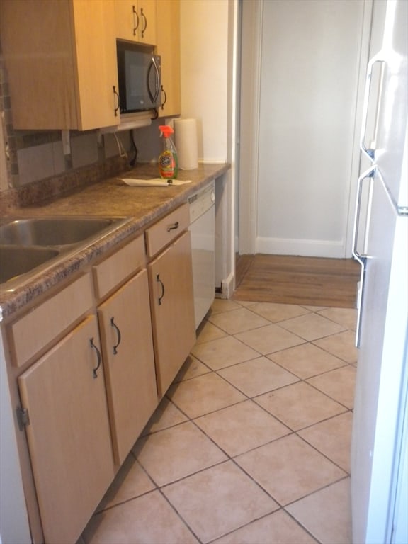 kitchen featuring light brown cabinets, white appliances, sink, and light hardwood / wood-style flooring