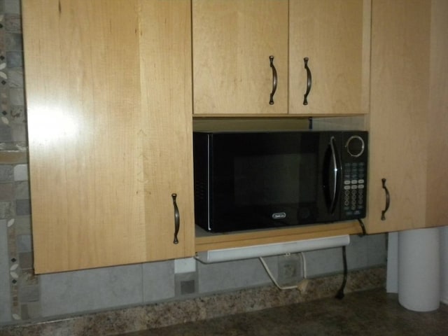 room details featuring light stone counters and light brown cabinets