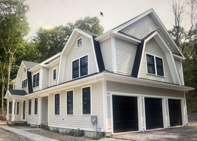 45 Widow Rites Ln, Sudbury, MA 01776 - view of front of home with a gambrel roof, a garage, and asphalt driveway