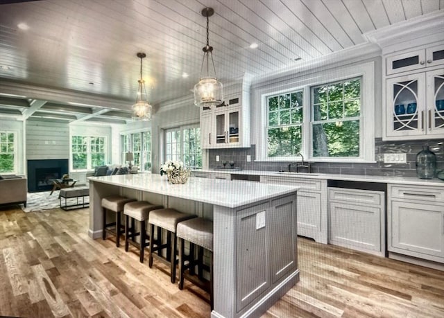45 Widow Rites Ln, Sudbury, MA 01776 - kitchen with open floor plan, wood ceiling, a sink, a breakfast bar, and light countertops