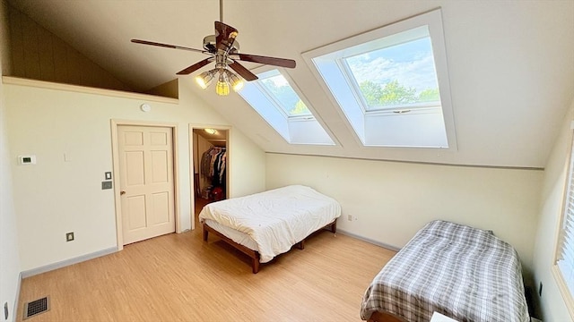 67 Amherst Rd Unit 67, South Hadley, MA 01075 - bedroom with vaulted ceiling, wood finished floors, a skylight, a walk in closet, and a closet