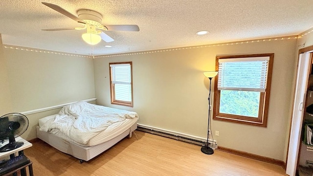 67 Amherst Rd Unit 67, South Hadley, MA 01075 - bedroom featuring baseboard heating, a textured ceiling, wood finished floors, a ceiling fan, and recessed lighting